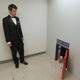 Nathan Fielder watches a customer crawl through a tiny door that supposedly leads to huge bargains. (Photo: Comedy Central)